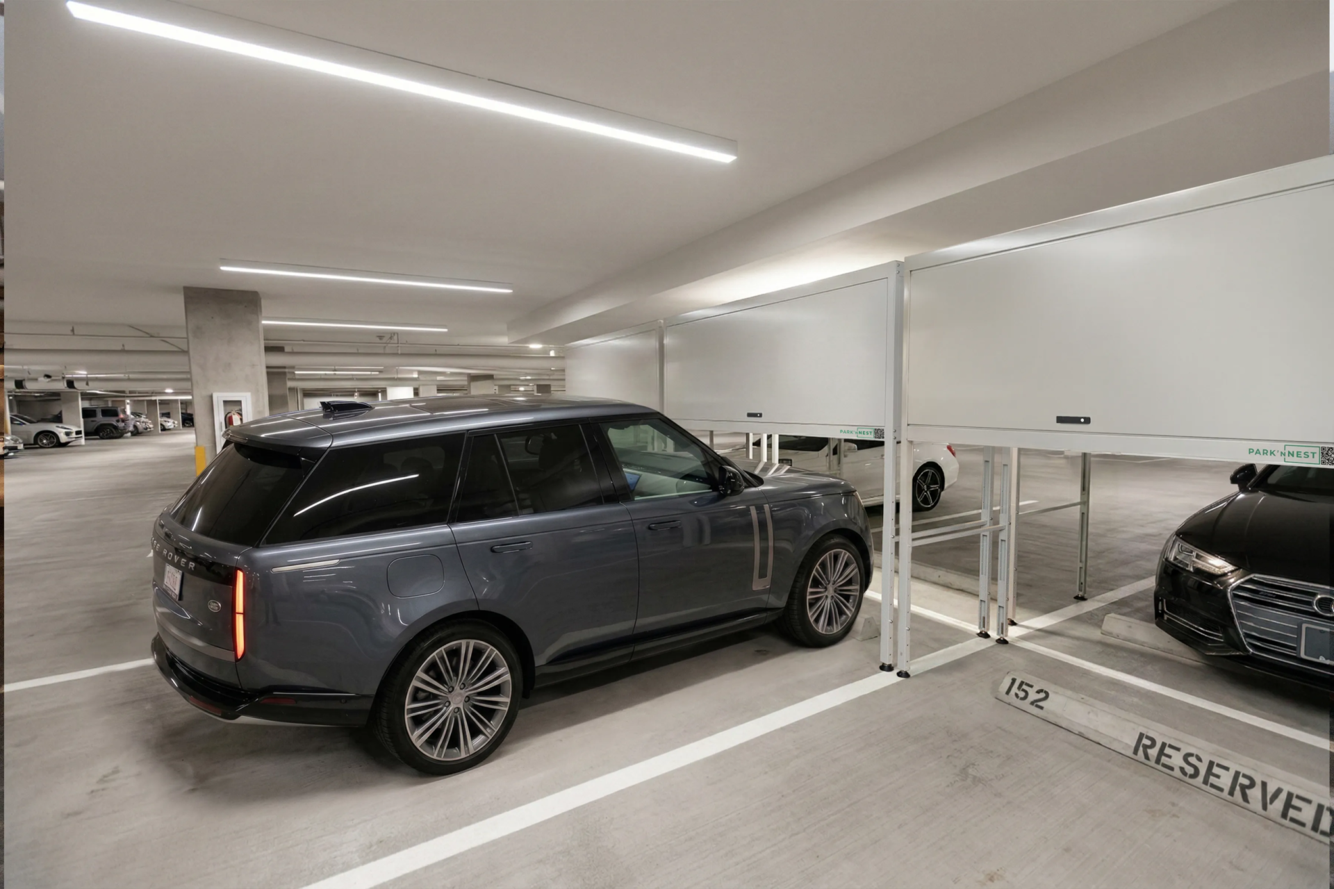 Park'ɴNest lockers installed above vehicles in a residential parking garage